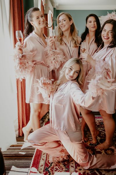 Galentine's theme ideas with groups of friends in pink feather pyjamas 