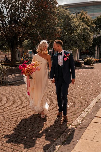 bride-in-cold-shoulder-feather-wedding-dress-with-groom-at-hackney-wedding