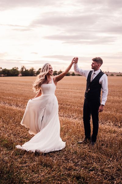 groom-spins-bride-around-for-wedding-photos