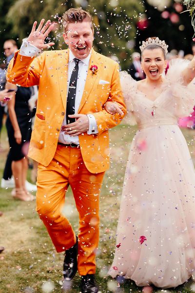 confetti moment at preston court wedding with pink wedding dress and yellow wedding suit