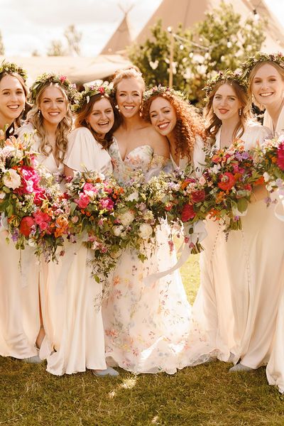 bridesmaids-wearing-ivory-dresses-with-flower-crowns-at-garden-wedding