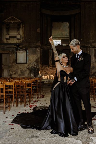 bride-wearing-custom-black-wedding-dress-with-groom-at-gothic-wedding