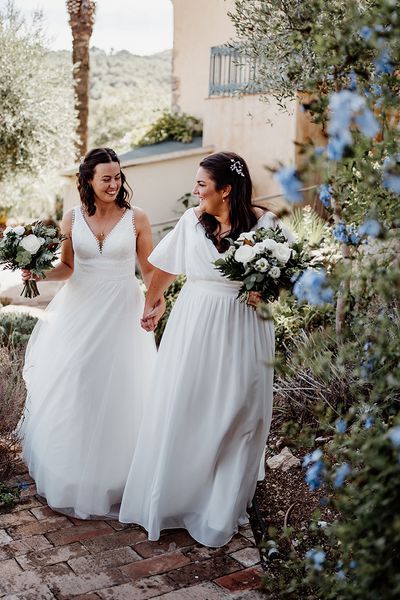 two-brides-wearing-floaty-wedding-dresses-at-destination-wedding