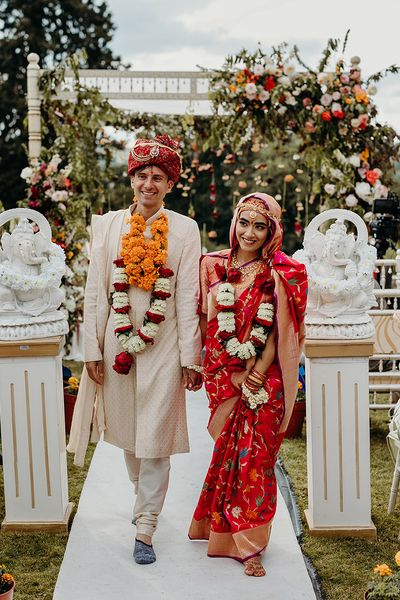 bride-and-groom-walking-back-down-the-aisle-at-hindu-wedding-ceremony-at-plas-dinam