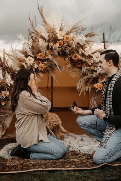 man-proposes-to-woman-in-boho-bell-tent