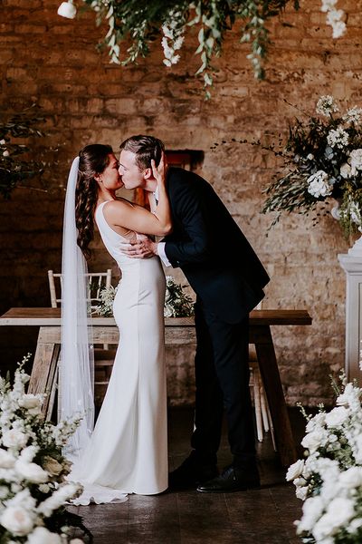 bride-and-groom-have-first-kiss-best-wedding-dates-2025