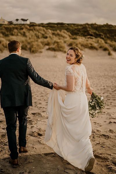 Bride in lace overlay wedding dress for coastal Irish wedding