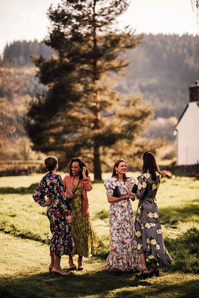 wedding guests wearing long sleeve floral wedding guest dresses for outdoor wedding