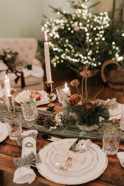 festive Christmas table decorations with green wedding decorations, including christmas crackers