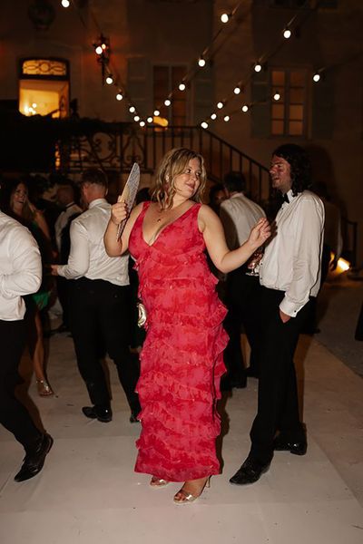 wedding guest wearing red ruffle dress for evening wedding celebrations