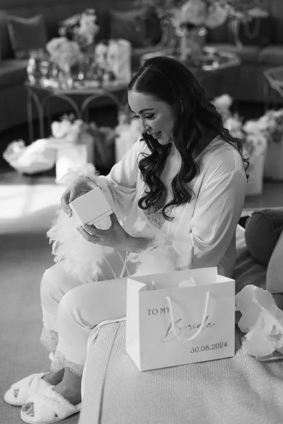 bride opening gifts on the wedding morning