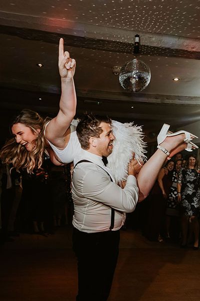 bride and groom having fun during their first dance for best oasis wedding songs