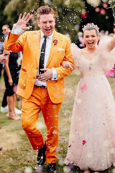 groom wearing colourful, unique mustard orange groom on wedding day