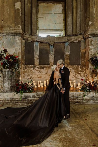 Bride wearing a black wedding dress with long train