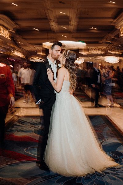 Couple kiss after black Thai wedding in the Bellagio casino in Las Vegas