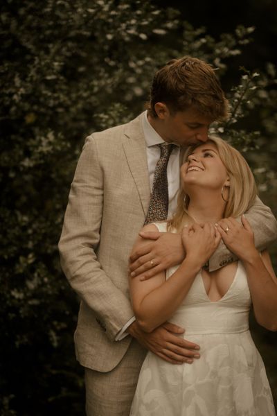 Wedding couple with foliage in background