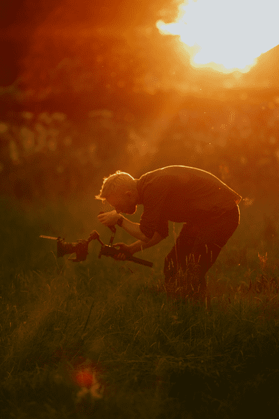 Graham filming in the grass...with an awesome sunset