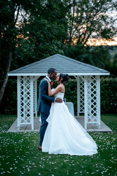 Bride and Groom standing in front of the altar, they hug and kiss.