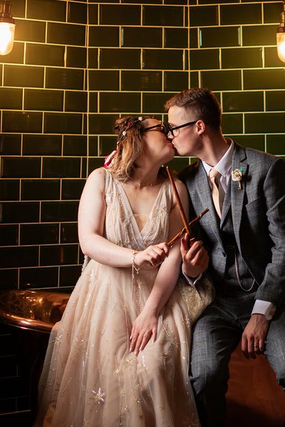 Bride and Groom in Ministry of Magic-Inspired Room by Booth & Curtis Photography