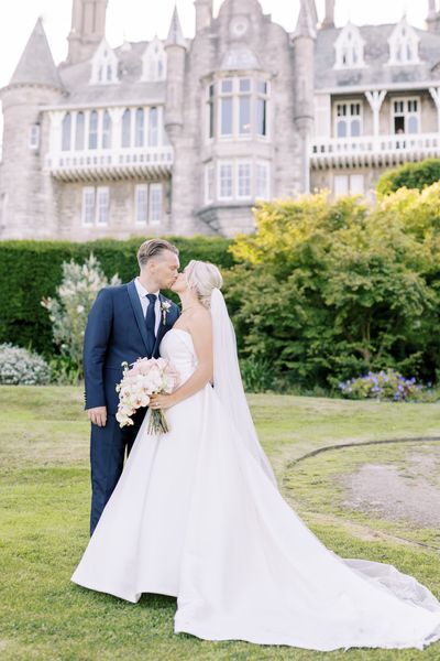 Bride and Groom in our gardens with the Chateau in the background by Heledd Roberts Photography