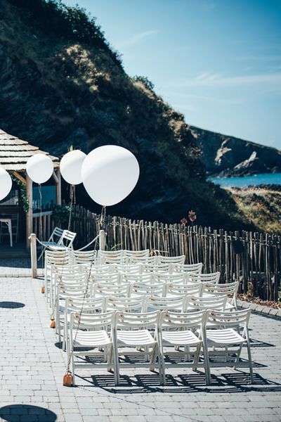 Gypsophila Arch and Giant Balloons for an Outdoor Coastal Wedding | Strapless Pronovias Ballgown Dress | ASOS Bridesmaids Dresses | Toby Lowe Photography