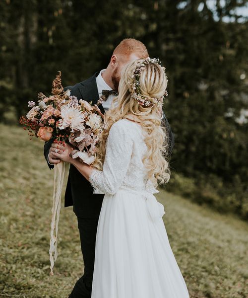 Dolomites Wedding on a mountain top with autumnal wedding bouquet and flower crown