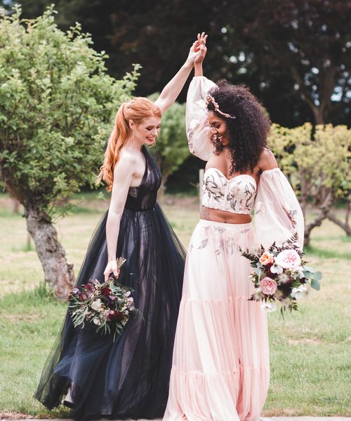 Autism marriage inclusive wedding inspiration with two brides in a black wedding dress and pink embroidered bridal separates