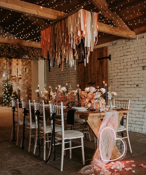 Eden Barn wedding with neon sign, fringe garland and black accent candles