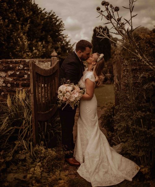 outdoor wedding at Dewsall court with bride in a lace cap sleeve wedding dress