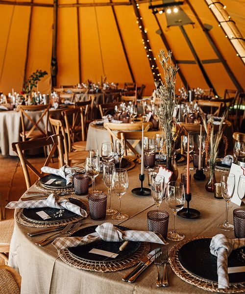 Tipi wedding with neutral wedding table decor and tablescape with warm lighting