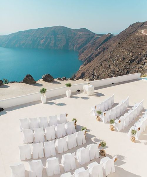 santorini wedding destination venue, ceremony area with chairs by the sea