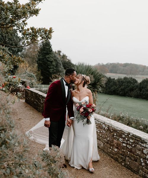 winter wedding at Berkeley Castle with red wedding suit jacket