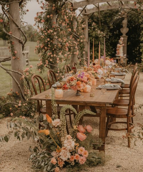 Summer wedding inspiration at Euridge Manor with orange, coral and peach wedding flowers and decor, and with Made With Love dresses