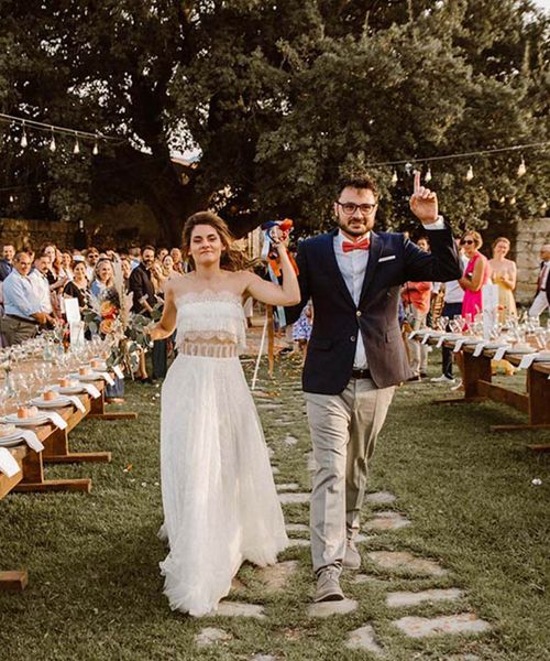 Greece destination wedding with strapless lace boho weddng dress, pampas grass decor, wool rugs & goat table plan by WedPashalis Photography