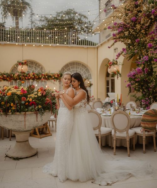 LGBTQIA+ Croatia wedding with two brides in lace wedding dresses and bright wedding flowers