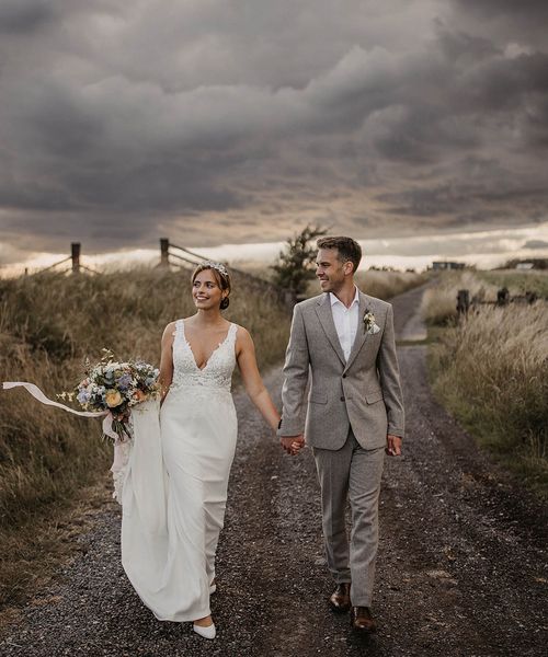 Elmley Nature Reserve wedding with bride and groom walking together