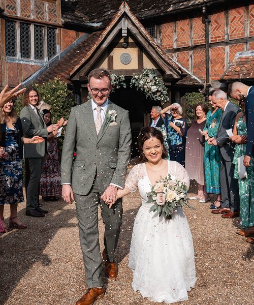 bride and groom have confetti exit at Langshott Manor in Surrey
