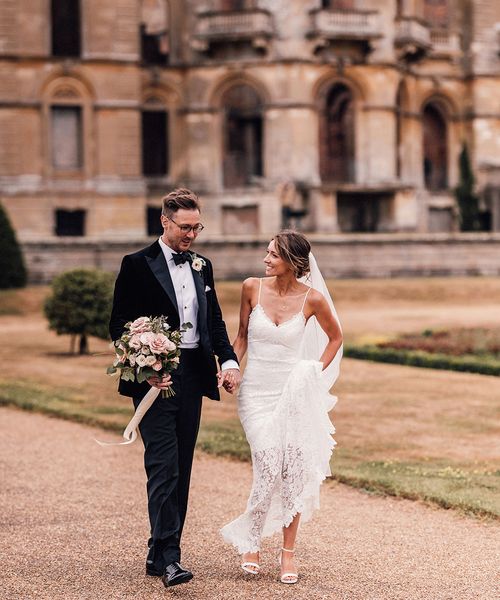 Bride in lace wedding dress and groom in black tuxedo for Hanley Hall Worcestershire wedding.