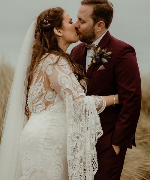 Boho Newton Hall wedding with the bride in a lace wedding dress.