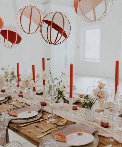 Modern Asian wedding decor ideas with orange and gold colour scheme, lanterns and embroidered napkins