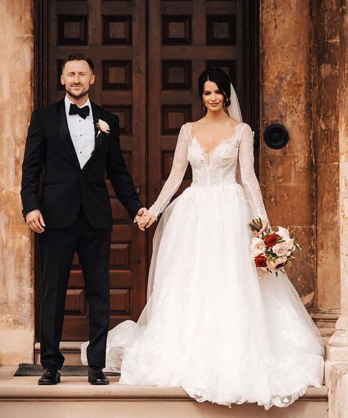 Bride in a Milla Nova princess style wedding dress and groom in black tie.