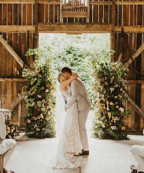 Bride and groom share their first kiss as a married couple at Nancarrow Farm.