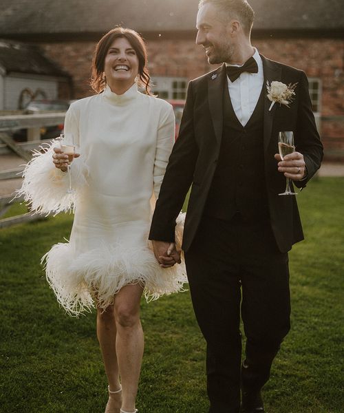 Bride wearing short winter wedding dress with feathers