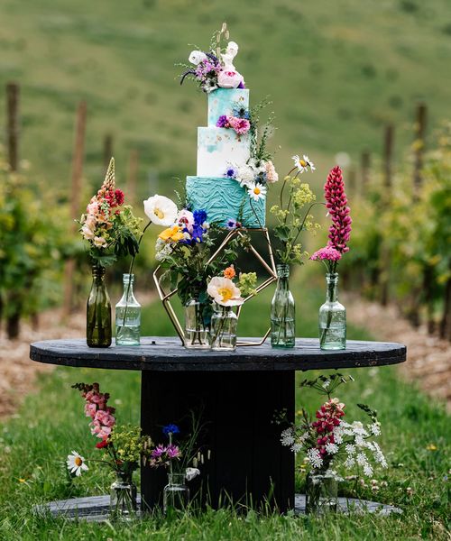 Colourful wedding inspiration at Little Wold Vineyard with wild flowers, buttercream cake and lace dresses 