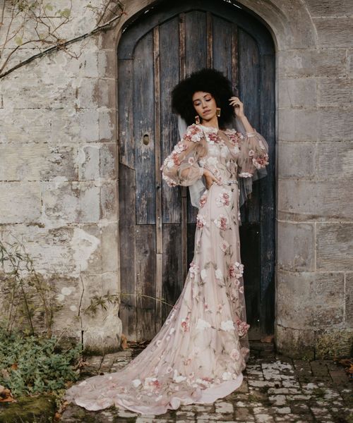 Black bride with afro hair in a 3D flower pink embroidered wedding dress at Chiddingstone Castle