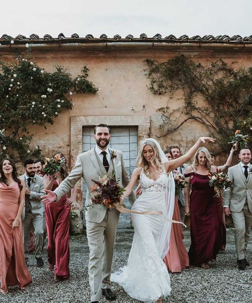 Tuscany destination wedding with lace wedding dress, tambourine favours and terracotta orange bridesmaid dresses