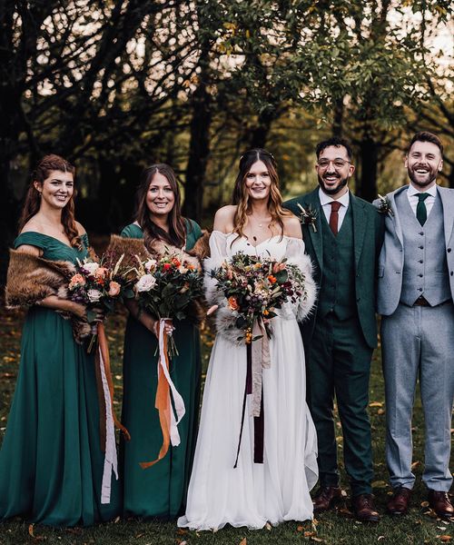 Forest green autumnal bridesmaid dresses for November wedding at Cripps Barn.