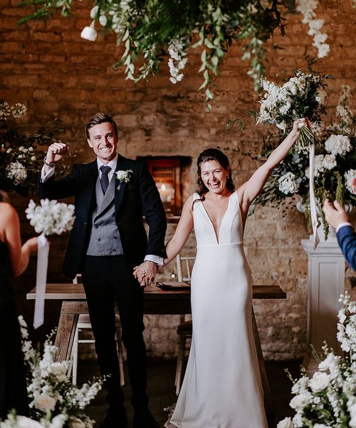 bride and groom exit form their ceremony at their barn wedding