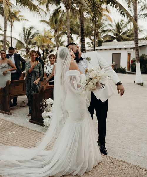 Modern Blue Venado beach wedding with white wedding flowers, disco balls, candles and black bridesmaid dresses by Andre Gouin