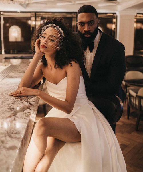 Stylish Mayfair Townhouse wedding inspiration with front slit wedding dress, birdcage veil and velvet suit jacket